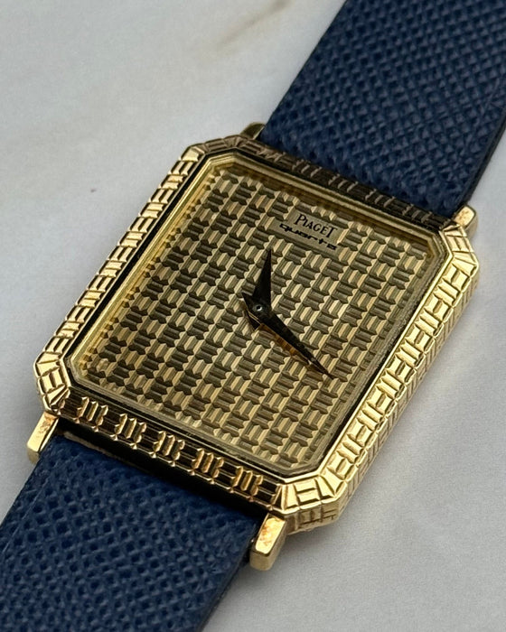 Elegant Piaget 7143 wristwatch featuring integrated gold grid motif and minimalist design, c. 1990s