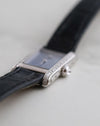 Angled macro view of the Cartier Mini Tank Ref. 1370 showing its diamond-set white gold case and pale blue dial.