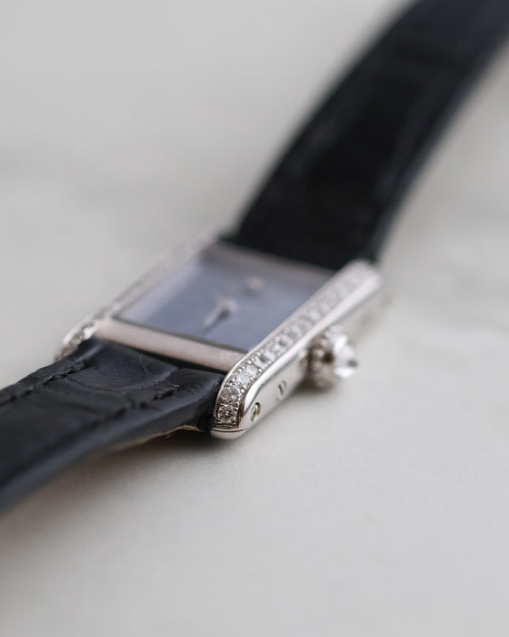 Angled macro view of the Cartier Mini Tank Ref. 1370 showing its diamond-set white gold case and pale blue dial.