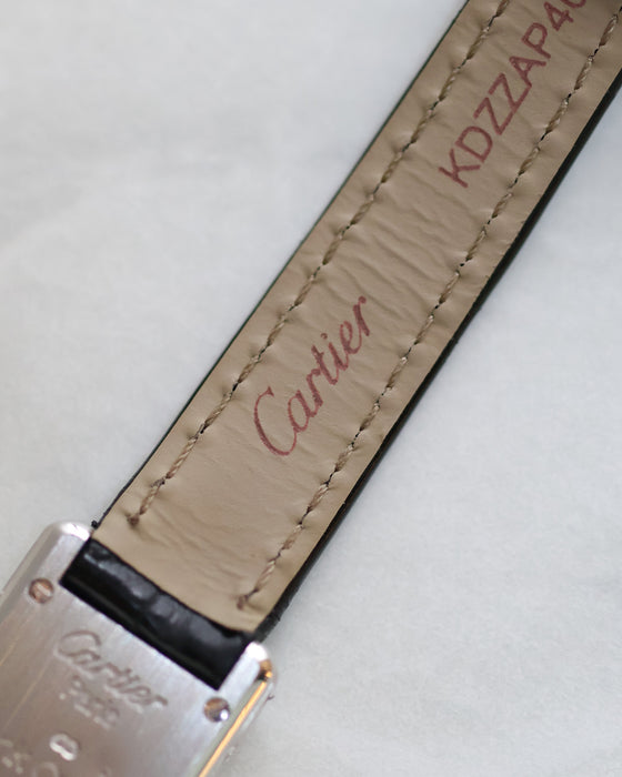 Underside of the original Cartier leather strap with Cartier signature and caseback partially visible.