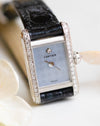 Front close-up of the Cartier Mini Tank featuring a pale blue chequered dial, diamond hour marker and diamond-set case sides.