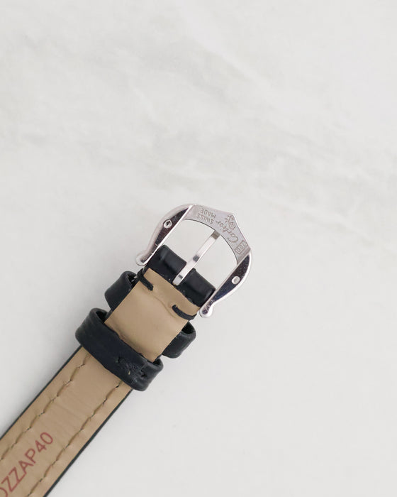 Original Cartier 18K white gold pin buckle showing engraved Cartier signature and gold hallmarks.
