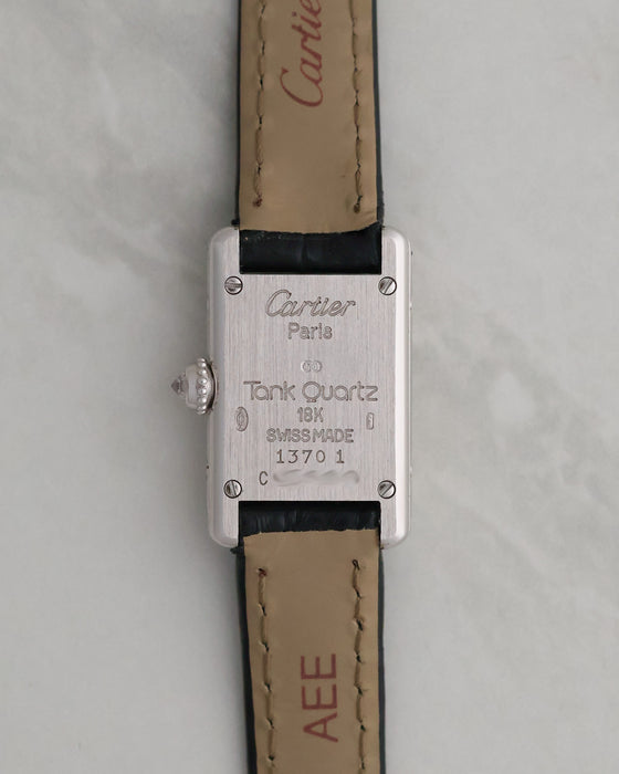 Caseback of the Cartier Mini Tank Ref. 1370 1 showing the Cartier Paris engraving, 18K gold marking and quartz designation.