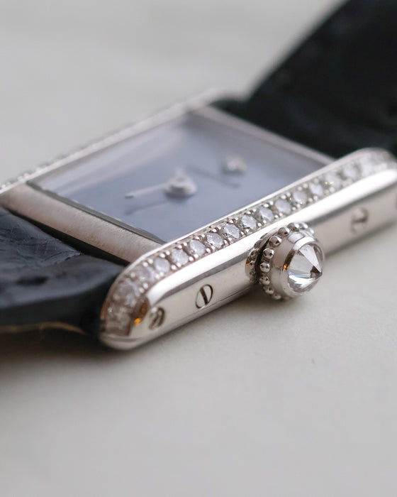 Side macro of the Cartier Mini Tank highlighting the diamond-set crown, polished case sides and diamond-set brancards.