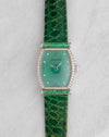 Front view of the Audemars Piguet Carnegie with green mother-of-pearl dial, diamond-set bezel, green gemstone-set bars and matching green leather strap.