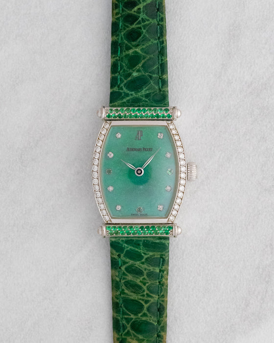 Front view of the Audemars Piguet Carnegie with green mother-of-pearl dial, diamond-set bezel, green gemstone-set bars and matching green leather strap.