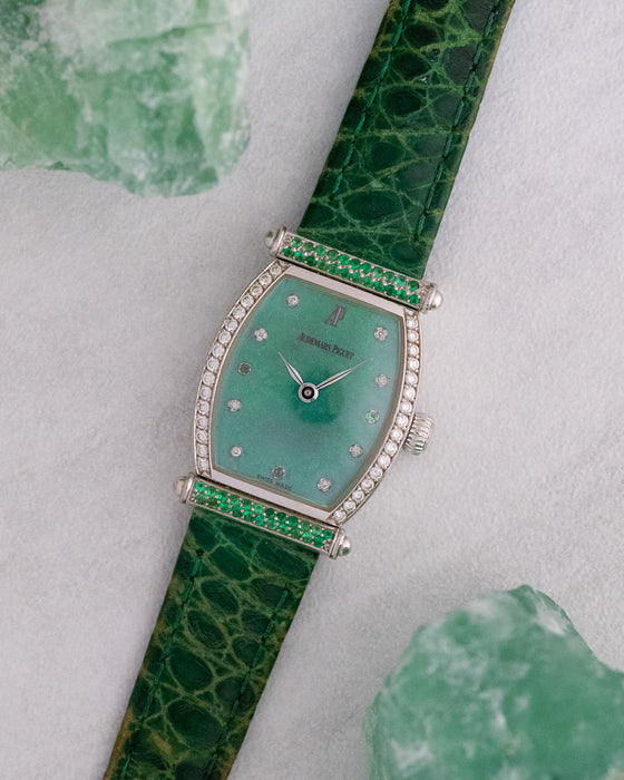 Angled view of the white gold Audemars Piguet Carnegie with its curved tonneau case and green dial.