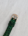 Original Audemars Piguet white gold pin buckle fitted to a green textured leather strap.