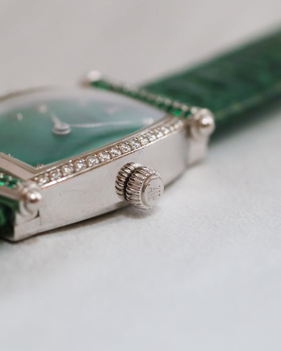 Close-up of the signed Audemars Piguet winding crown beside the diamond-set case.
