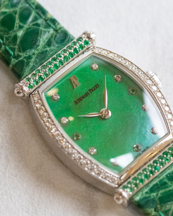 Detailed view of the green mother-of-pearl dial with diamond and green gemstone hour markers, AP signature and leaf-shaped hands.