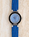 Front view of the Gérald Genta G3338.7 showing its blue geometric dial, black bezel and original blue leather strap.