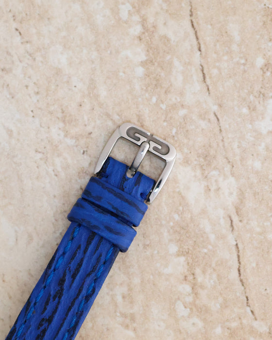 Close-up of the original Gérald Genta stainless steel pin buckle and blue textured leather strap.