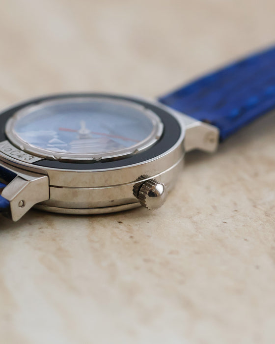 Close-up of the Gérald Genta stainless steel case showing its crown, black bezel and faceted crystal.