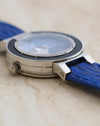 Side view highlighting the faceted crystal, black bezel and polished stainless steel case.