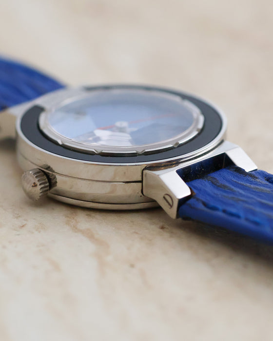 Side view highlighting the faceted crystal, black bezel and polished stainless steel case.