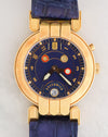 Front view of Harry Winston Greenwich GMT with blue dial, gold numerals, dual day/night indicators and 18K yellow gold case.