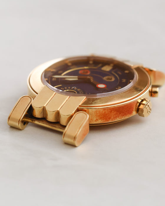 Low-angle view of Harry Winston Greenwich highlighting the gold case, raised crystal and three-arched lugs.