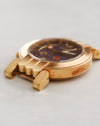 Opposite side profile of Harry Winston Greenwich showing the engraved case flank and distinctive gold lugs.