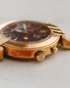 Close-up of Harry Winston Greenwich showing the signed crown, case-side pusher and surface patination.