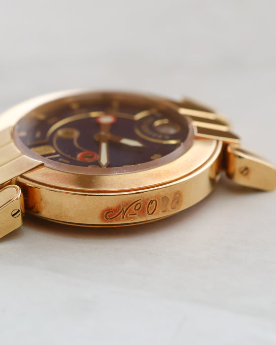 Detailed photograph of the numbered 18K yellow gold case flank of the Harry Winston Greenwich.