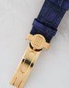 Original Harry Winston gold deployant clasp attached to a blue leather strap with an embossed HW emblem.