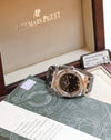 Audemars Piguet Royal Oak Lady 67601ST with black dial and diamond bezel displayed alongside its original box and warranty documentation.