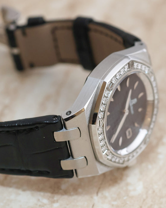 Three-quarter side view showing the Royal Oak Lady diamond bezel, sculpted lugs and black leather strap.
