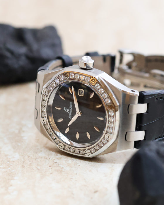 Three-quarter view of the Audemars Piguet Royal Oak Lady with black textured dial, diamond bezel and stainless steel case.