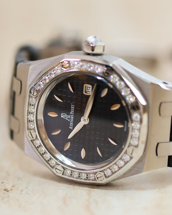 Close-up of the Audemars Piguet Royal Oak Lady black textured dial with leaf-shaped hour markers and factory diamond bezel.