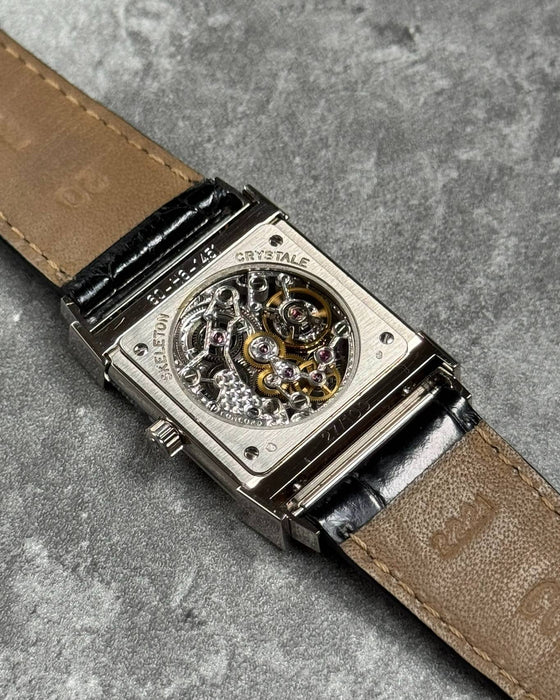 Exhibition case back of Concord Crystal Skeleton showing engraved Peseux 7000 manual movement in white gold case
