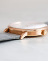Side profile of the rose gold Saxonia showing its polished bezel, brushed caseband and signed crown.