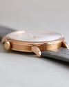 Side profile of the rose gold Saxonia showing its polished bezel, brushed caseband and signed crown.