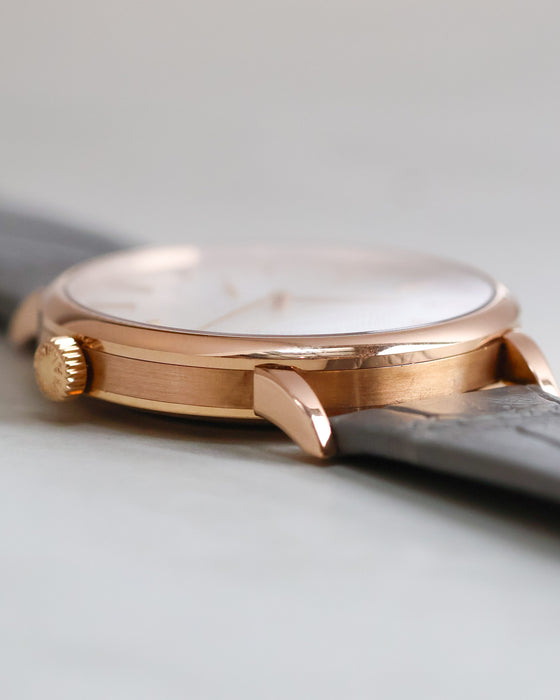 Side profile of the rose gold Saxonia showing its polished bezel, brushed caseband and signed crown.