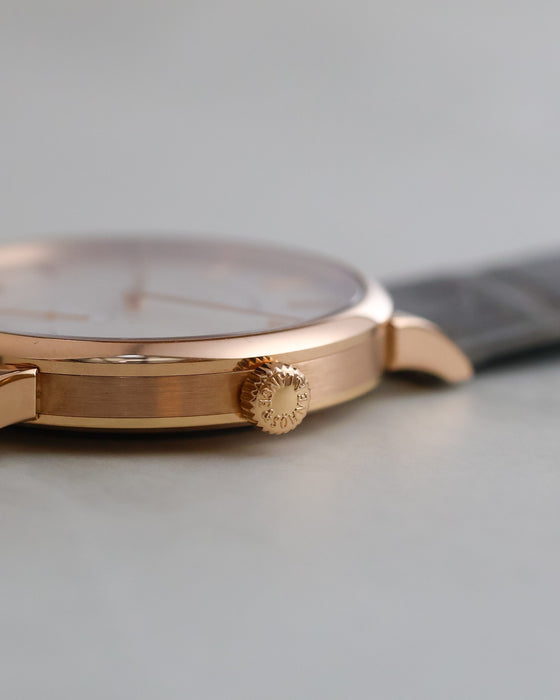 Detailed view of the A. Lange & Söhne signed winding crown and brushed rose gold case.