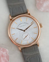 Angled photograph of the rose gold Saxonia with grey leather strap and natural mother-of-pearl dial.