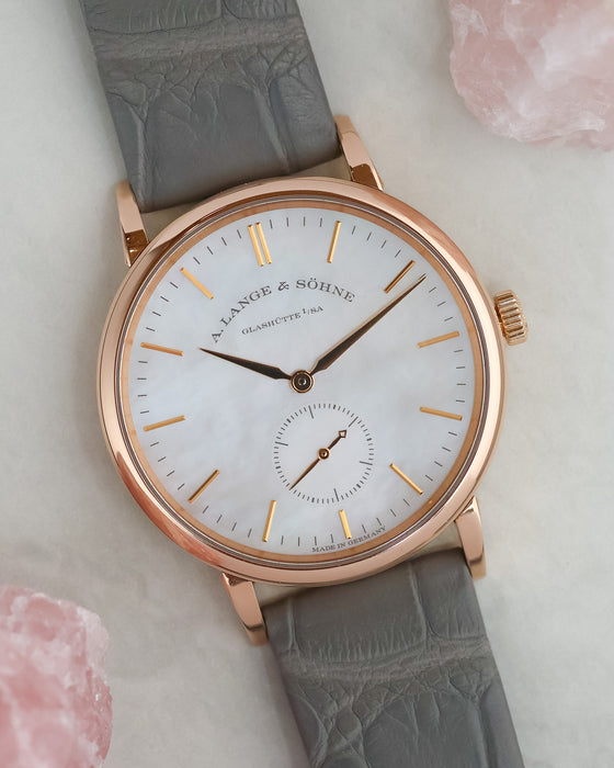 Angled photograph of the rose gold Saxonia with grey leather strap and natural mother-of-pearl dial.