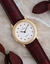 Angled view of the Blancpain Villeret 0096 showing its pink gemstone dial, polished yellow gold case and burgundy leather strap.