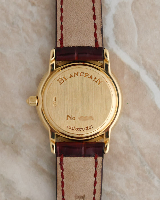 Solid 18K yellow gold caseback of the Blancpain Lady Villeret featuring engraved Blancpain branding and automatic designation.