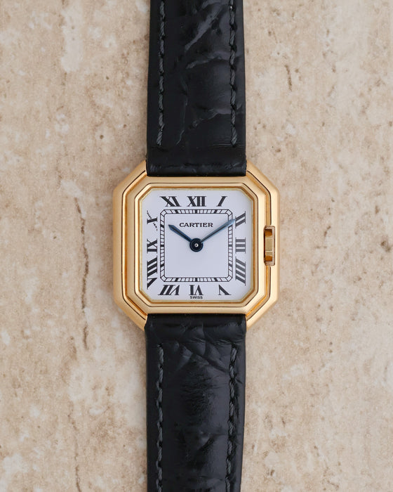 Cartier Ceinture Ref. 6602 in 18K yellow gold, featuring a white Roman numeral dial and black leather strap.