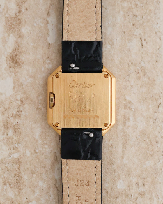 Rear view of Cartier Ceinture Ref. 6602 showing the engraved 18K yellow gold caseback and four securing screws.