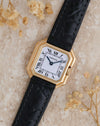 Angled overhead photograph of the Cartier Ceinture 6602 showcasing its stepped gold case and blued steel hands.