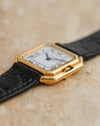 Low-angle side view highlighting the recessed crown and layered construction of the Cartier Ceinture gold case.