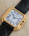 Detailed dial photograph showing the Cartier signature, Roman numerals, blued steel hands and recessed crown.