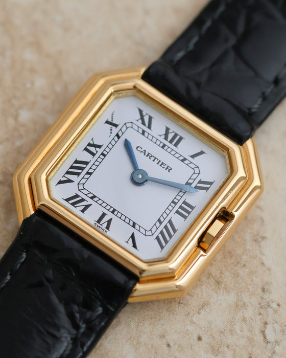 Detailed dial photograph showing the Cartier signature, Roman numerals, blued steel hands and recessed crown.