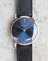 Front-facing view of a vintage Audemars Piguet white gold dress watch with a blue sunburst dial and black leather strap.