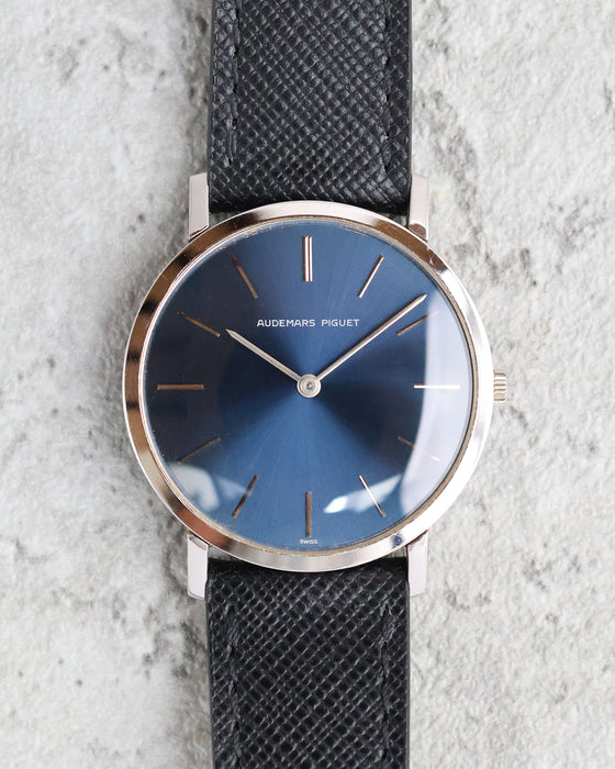 Front-facing view of a vintage Audemars Piguet white gold dress watch with a blue sunburst dial and black leather strap.