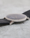 Low-angle photograph showing the polished bezel, raised crystal and slender profile of the Audemars Piguet dress watch.