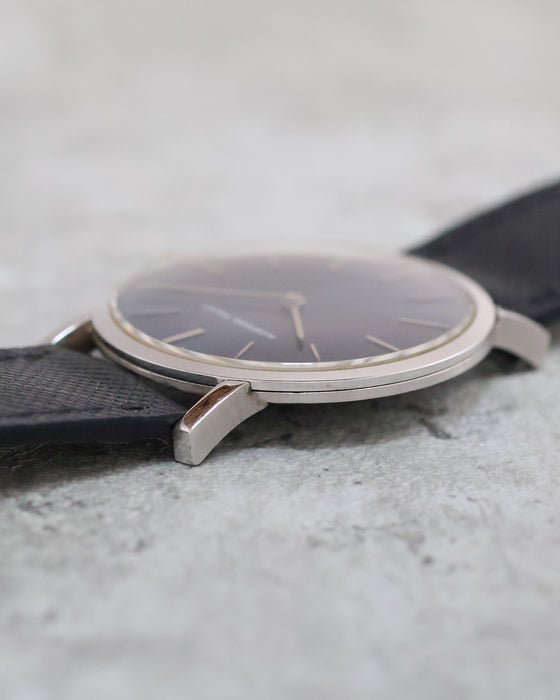 Low-angle photograph showing the polished bezel, raised crystal and slender profile of the Audemars Piguet dress watch.