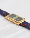 Low-angle side view of the Chopard Dual Time showing its raised rectangular dials and polished yellow gold case.