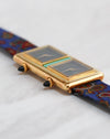 Angled view showing the two separate dial assemblies, turquoise centrepiece and double crowns.